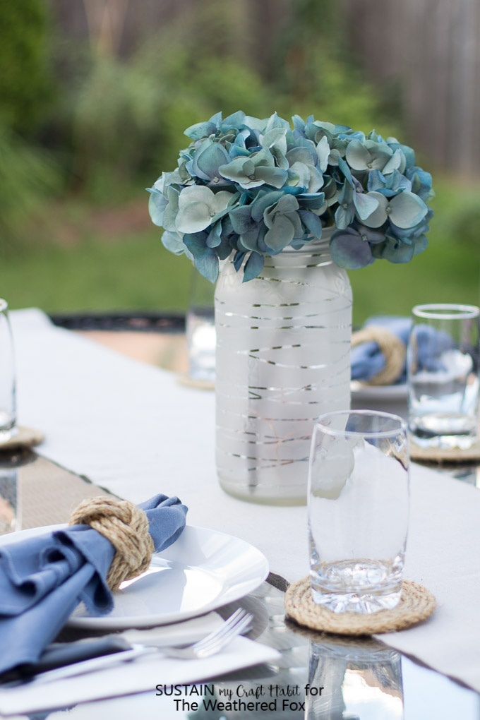 DIY wedding or summer table centerpiece. Upcycled pickle jar craft. Mason jar upcycling idea. Summer patio lantern.