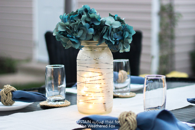 Gorgeous DIY faux floral centerpiece: an upcycled, frosted glass jar with silk hydrangeas.