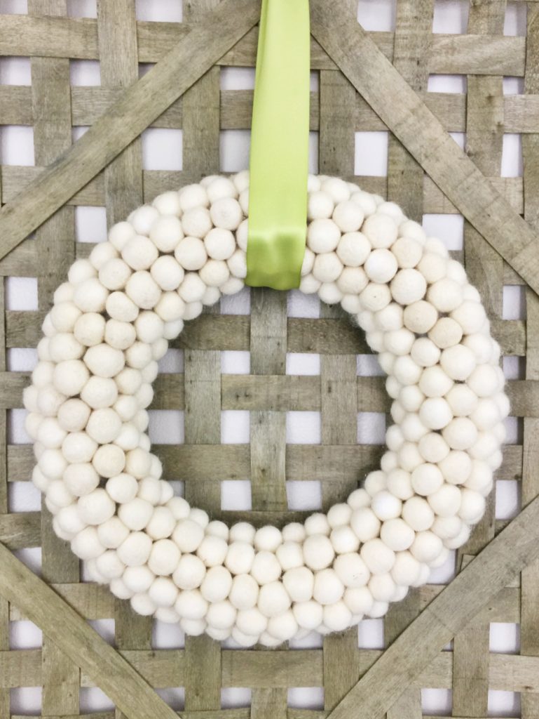 If you’re loving pom pom crafts, then you are going to love this white felt ball wreath tutorial! I show you how to make an easy felt pom pom wreath that will look amazing as part of your home decor for any season!