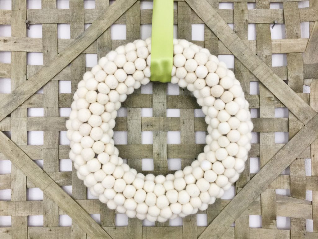 If you’re loving pom pom crafts, then you are going to love this white felt ball wreath tutorial! I show you how to make an easy felt pom pom wreath that will look amazing as part of your home decor for any season!