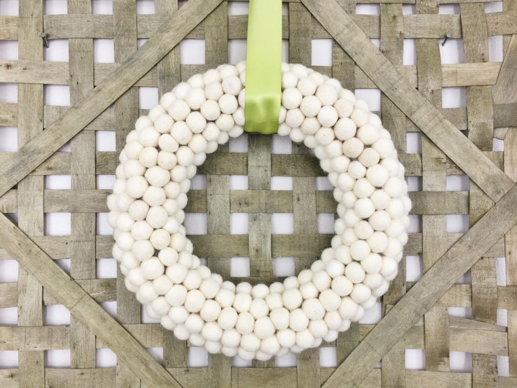 If you’re loving pom pom crafts, then you are going to love this white felt ball wreath tutorial! I show you how to make an easy felt pom pom wreath that will look amazing as part of your home decor for any season!