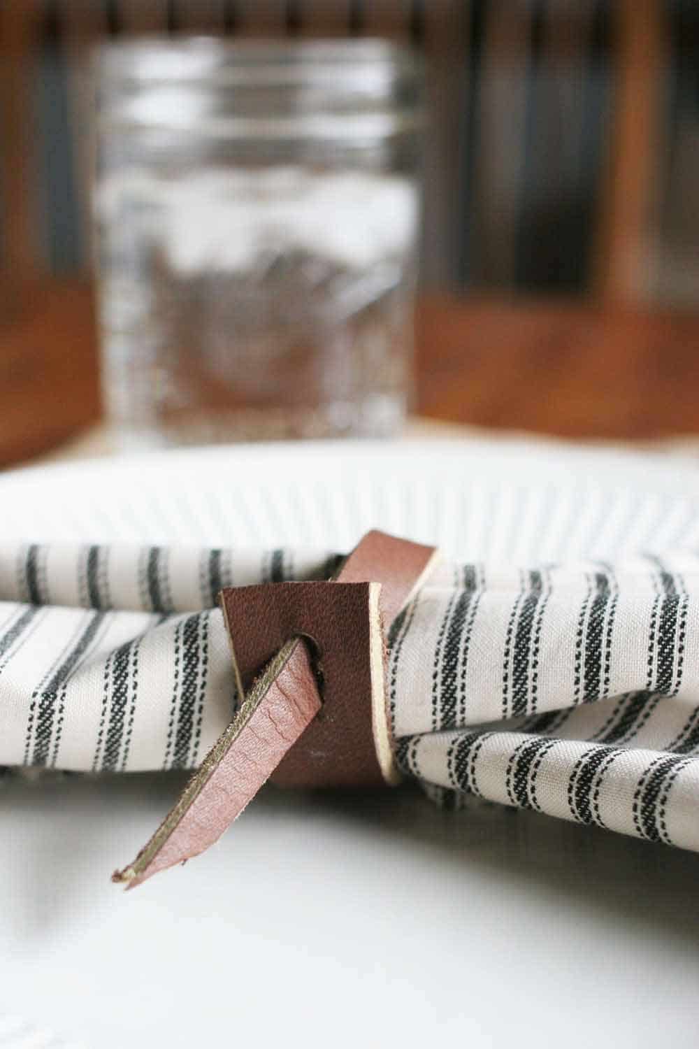 leather napkin ring, ticking cloth napkin